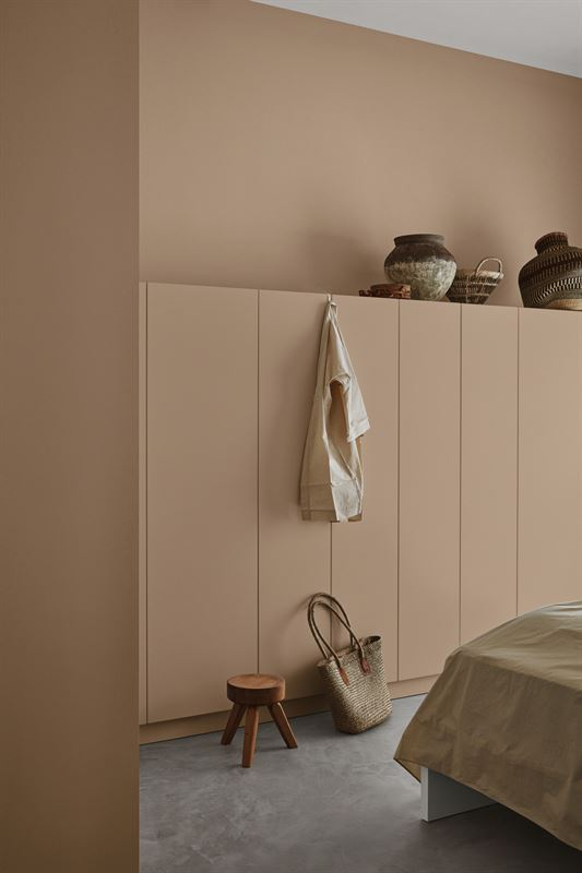 Hidden bedroom storage, cupboards which blend in with the painted wall behind. 