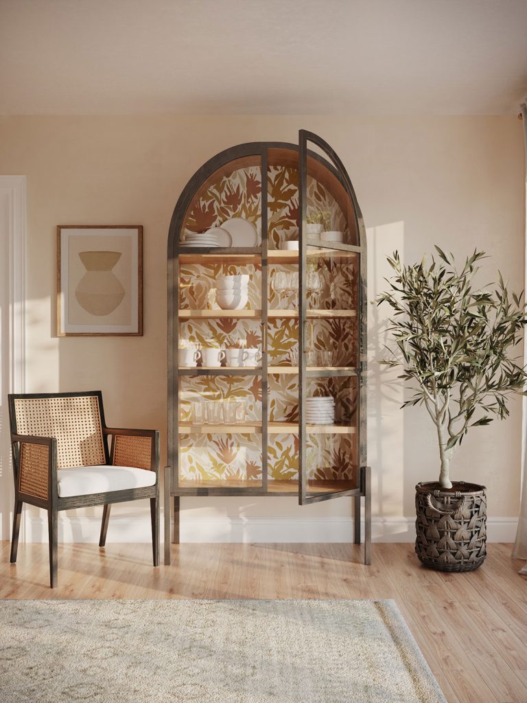 a glass front crockery cabinet with floral wallpaper in the back