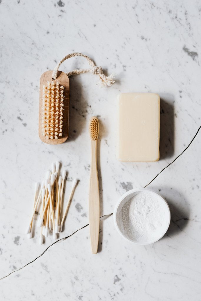 Flat lay of a nail brush, soap, and toothbrush