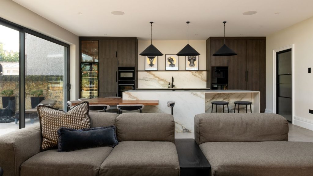 A wide angled shot of an open plan kitchen/living space