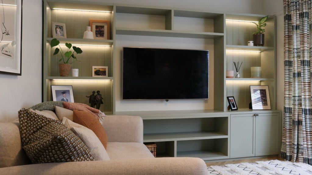A media console that incorporates back lighting on the shelves as an alternative lighting source.